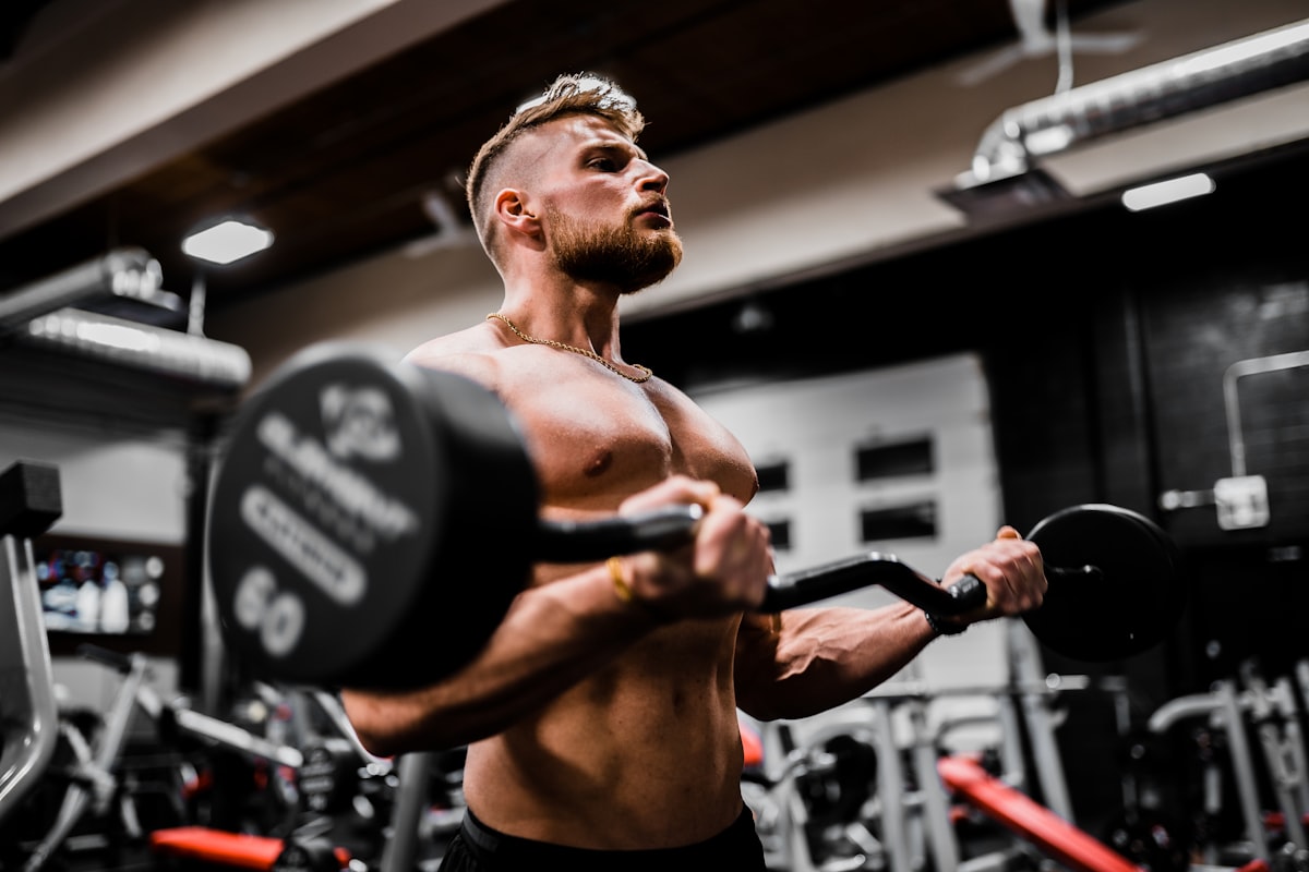 Man curling a barbell in a gym
